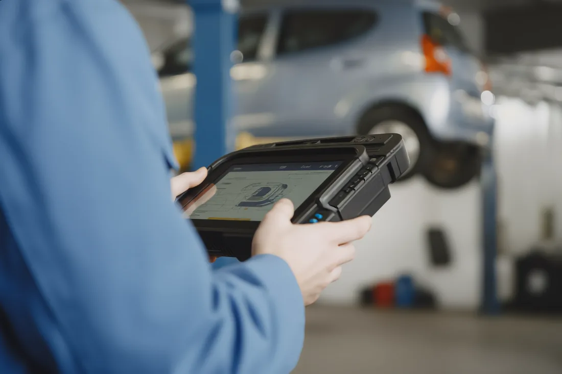 A service advisor reviewing a digital vehicle inspection on a tablet
